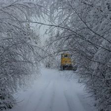 Maastoauto ajaa lumisella tiellä